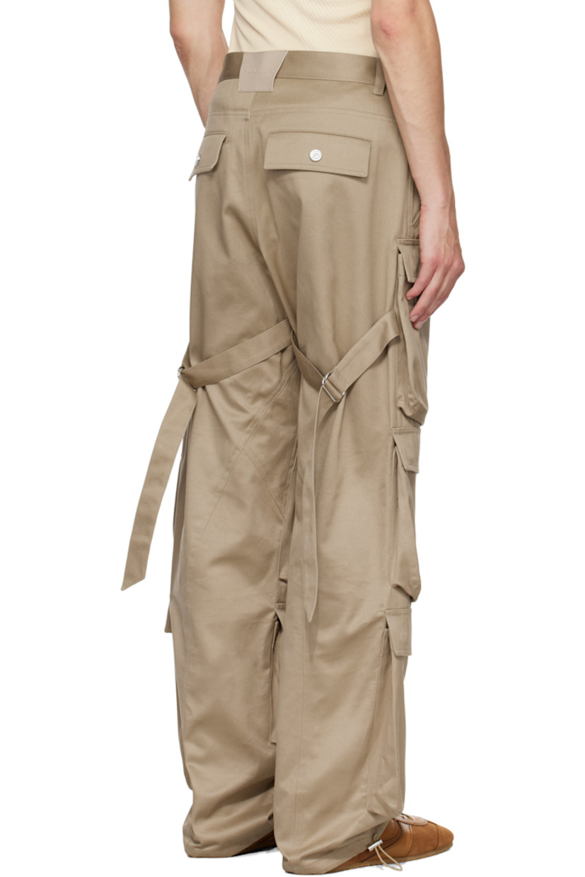 Cotton twill cargo pants.

· Loose-fit
· Belt loops
· Four-pocket styling
· Zip fly
· Cargo pockets at front legs
· Bungee-style drawstring at cuffs
· Rubberized logo patch at back waistband
· Cinch strap at back legs

Supplier color: Beige