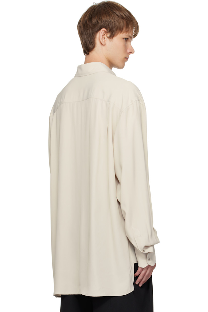 Plain-woven viscose shirt.

· Spread collar
· Graphic hardware at button closure
· Patch pocket at chest
· Droptail hem
· Buttoned barrel cuffs
· Pleats at back yoke

Supplier color: Sand