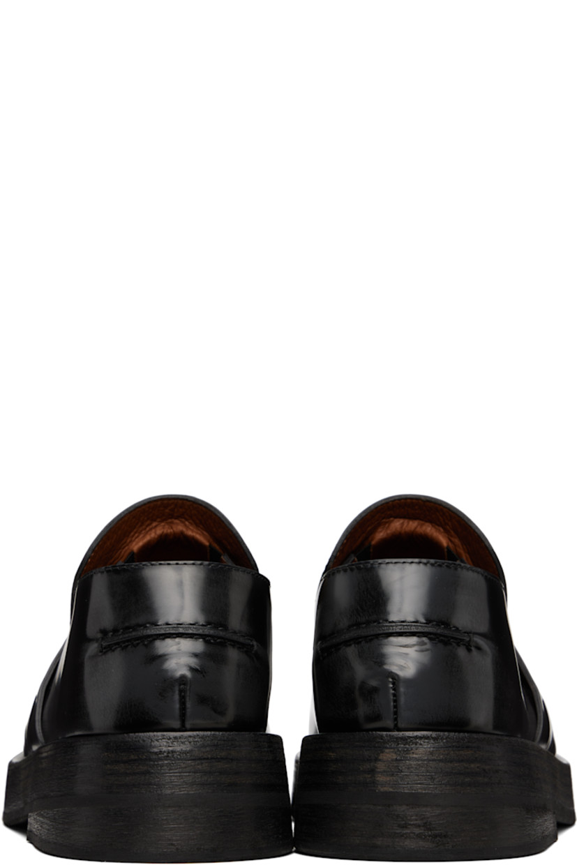 Polished leather loafers in black.

· Moc toe
· Strap with cutout at vamp
· Pinched seam at heel counter
· Buffed leather lining 
· Stacked leather heel and midsole
· Rubber sole

Supplier color: Black-lead