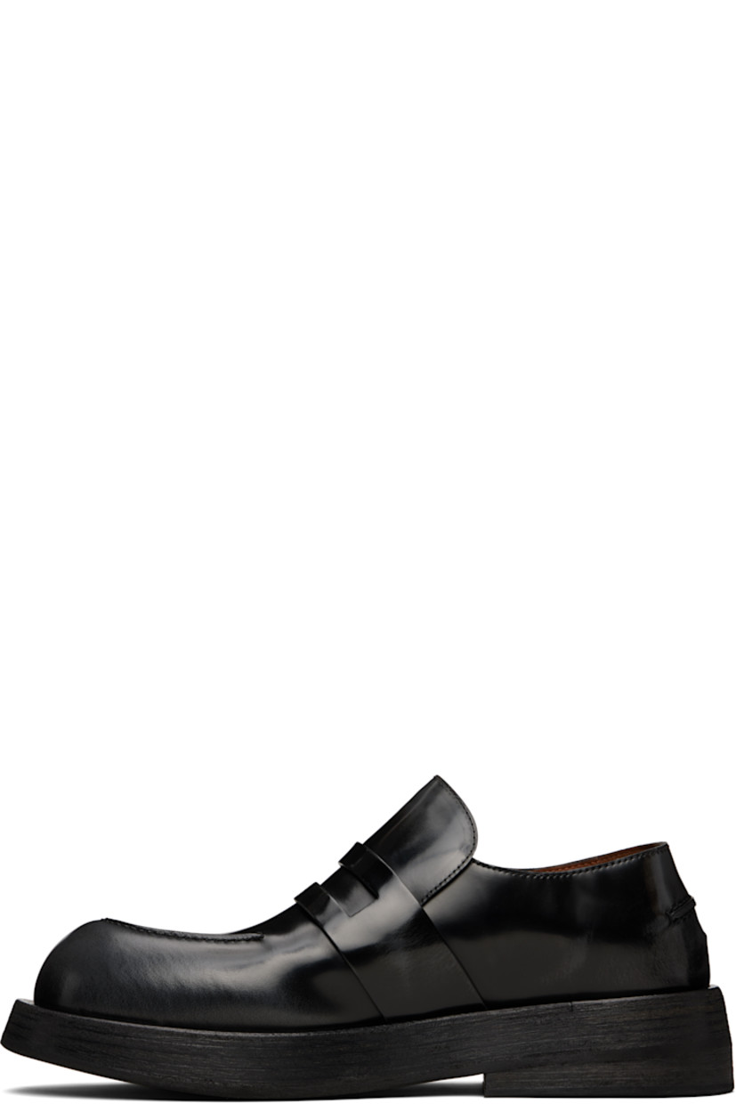 Polished leather loafers in black.

· Moc toe
· Strap with cutout at vamp
· Pinched seam at heel counter
· Buffed leather lining 
· Stacked leather heel and midsole
· Rubber sole

Supplier color: Black-lead