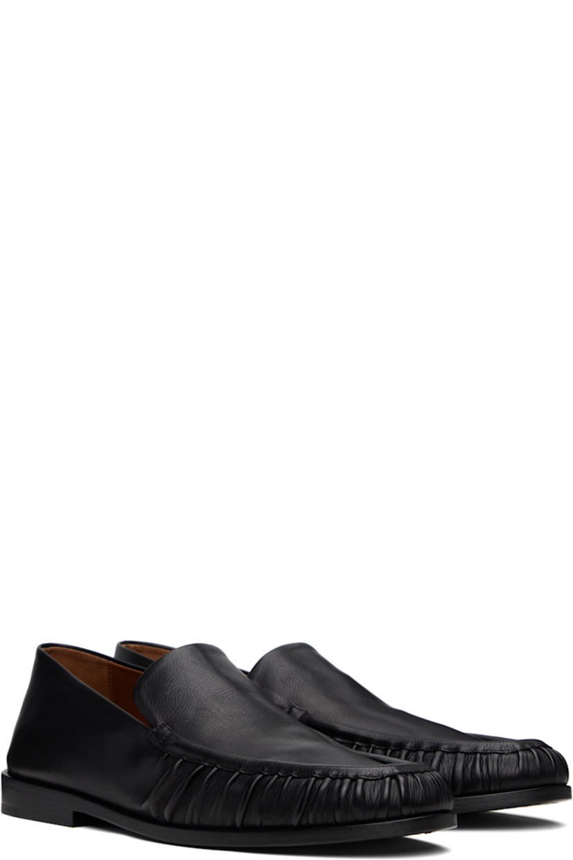 Buffed leather loafers.

· Gathering at moc toe
· Stacked leather heel with rubber injection
· Leather sole

Supplier color: Black