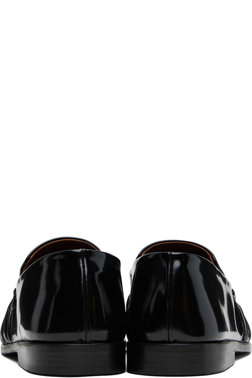 Patent leather loafers.

· Gathering at moc toe
· Buffed leather lining
· Stacked leather heel with rubber injection
· Leather sole

Supplier color: Black