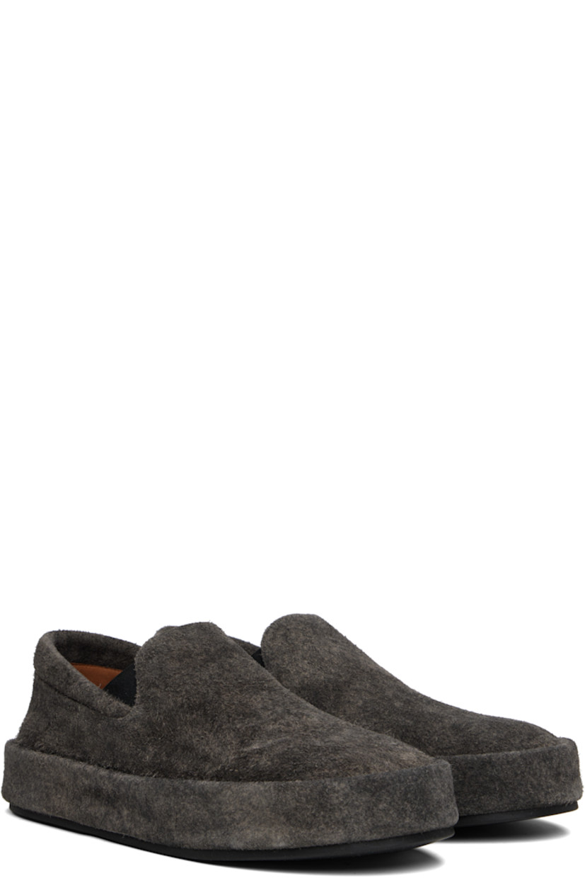 Low-top suede slip-on sneakers.

· Padded collar
· Elasticized gusset at sides
· Buffed leather lining
· Rubber sole

Supplier color: Black