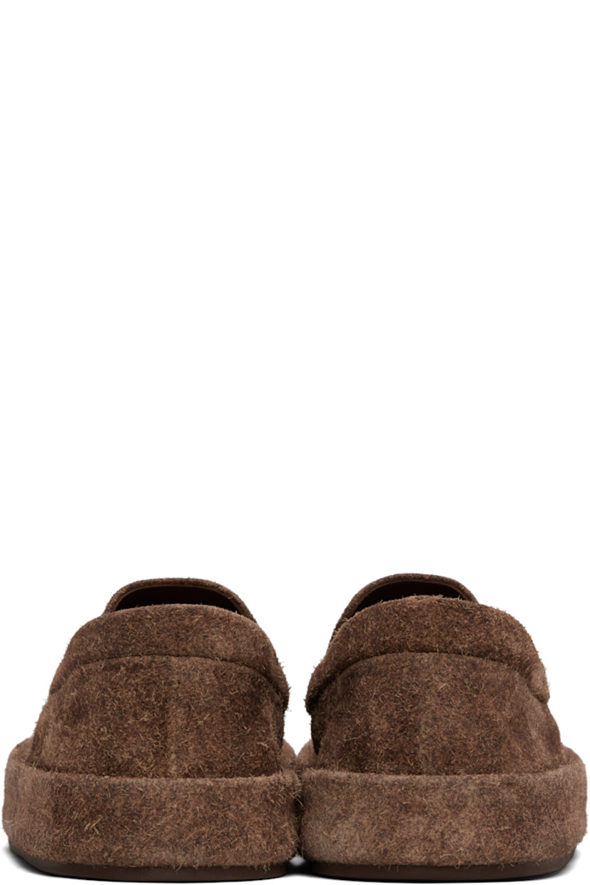 Low-top suede slip-on sneakers.

· Padded collar
· Elasticized gusset at sides
· Buffed leather lining
· Rubber sole

Supplier color: Dark brown
