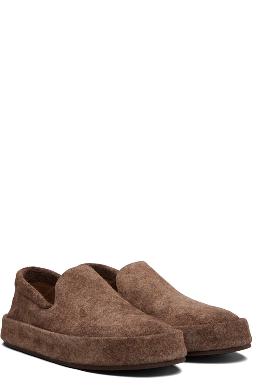 Low-top suede slip-on sneakers.

· Padded collar
· Elasticized gusset at sides
· Buffed leather lining
· Rubber sole

Supplier color: Dark brown