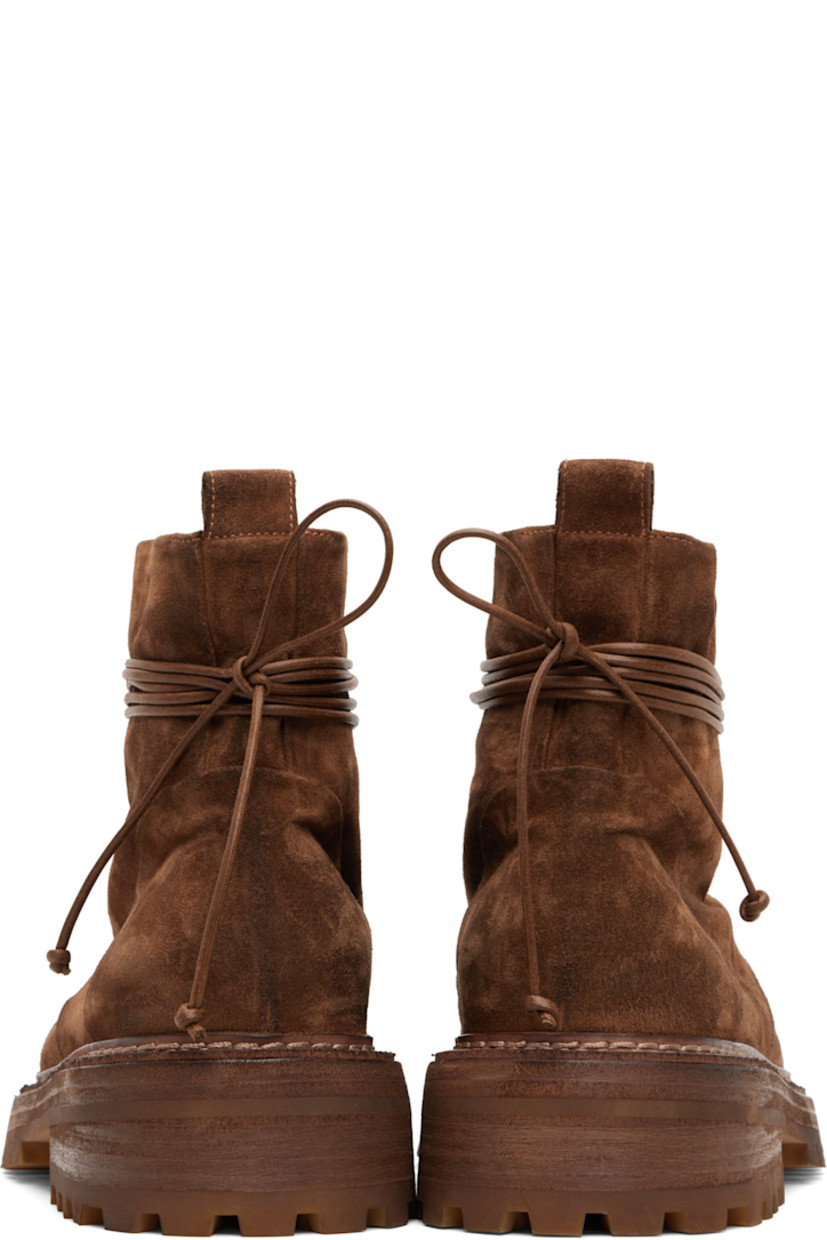 Ankle-high suede boots.

· Lace-up closure
· Pull-loop at heel collar
· Buffed leather lining
· Topstitching at welt
· Stacked leather and rubber heel and midsole
· Lugged rubber sole
· Heel: H2"

Supplier color: Basalt