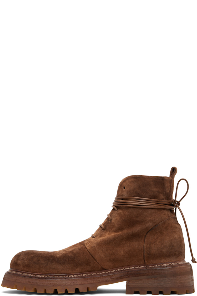 Ankle-high suede boots.

· Lace-up closure
· Pull-loop at heel collar
· Buffed leather lining
· Topstitching at welt
· Stacked leather and rubber heel and midsole
· Lugged rubber sole
· Heel: H2"

Supplier color: Basalt