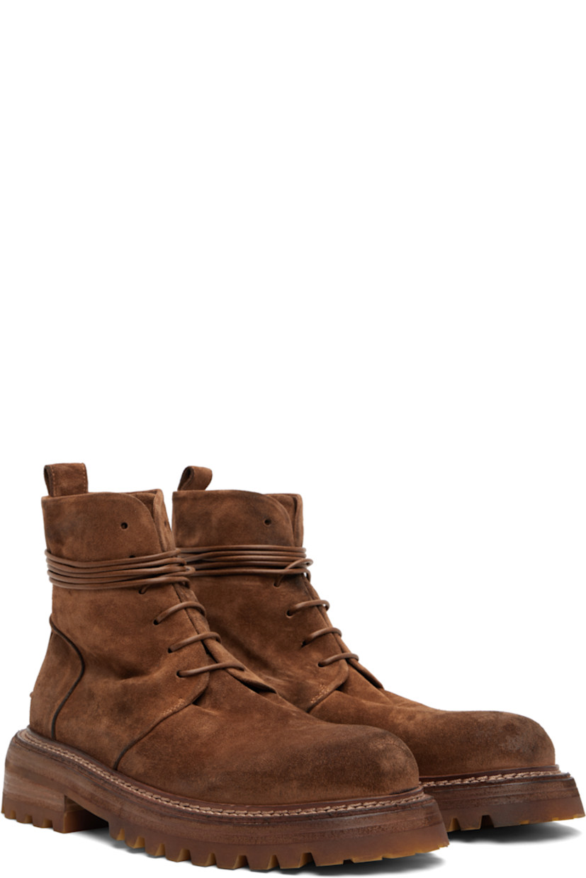 Ankle-high suede boots.

· Lace-up closure
· Pull-loop at heel collar
· Buffed leather lining
· Topstitching at welt
· Stacked leather and rubber heel and midsole
· Lugged rubber sole
· Heel: H2"

Supplier color: Basalt