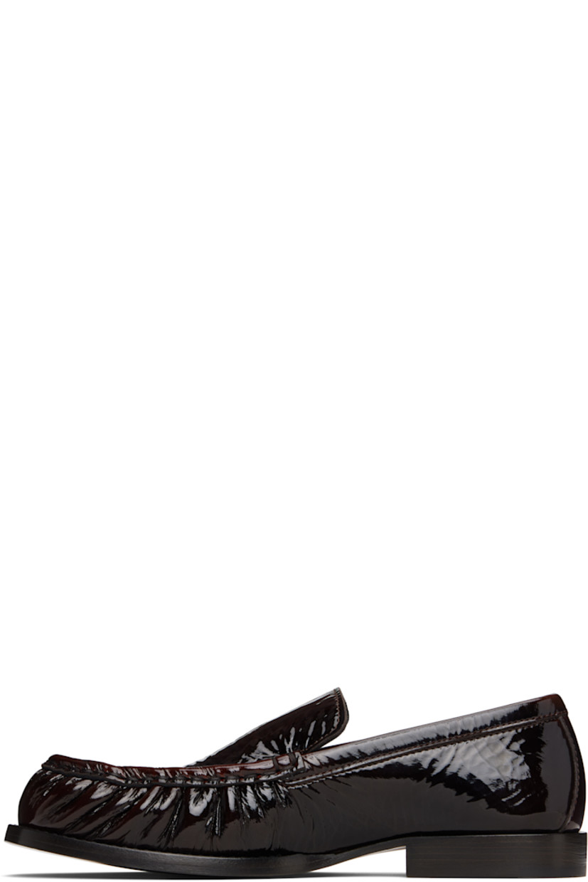Patent leather loafers.

· Moc toe
· Buffed leather lining
· Stacked leather heel with rubber injection
· Leather sole

Supplier color: Brown