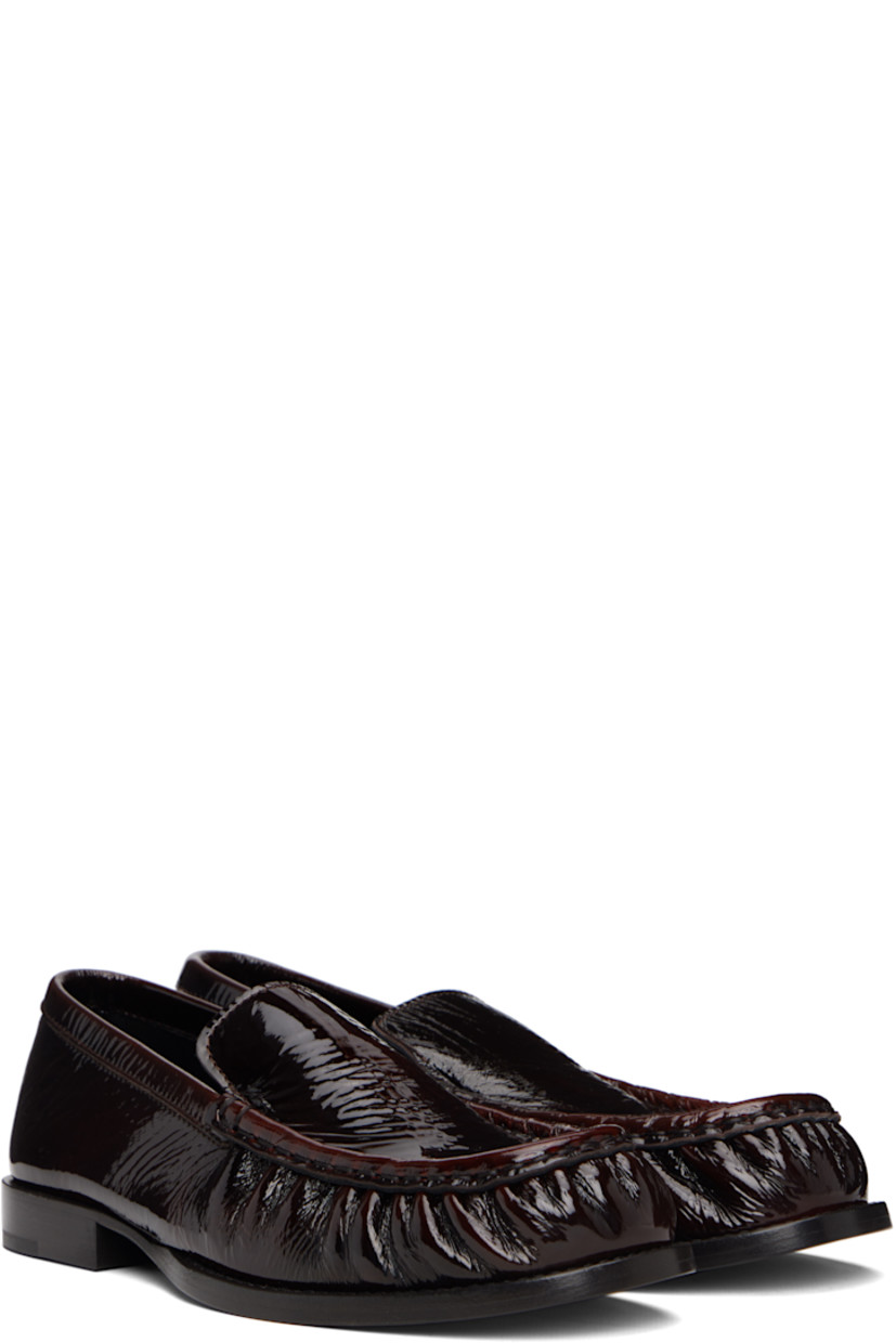 Patent leather loafers.

· Moc toe
· Buffed leather lining
· Stacked leather heel with rubber injection
· Leather sole

Supplier color: Brown