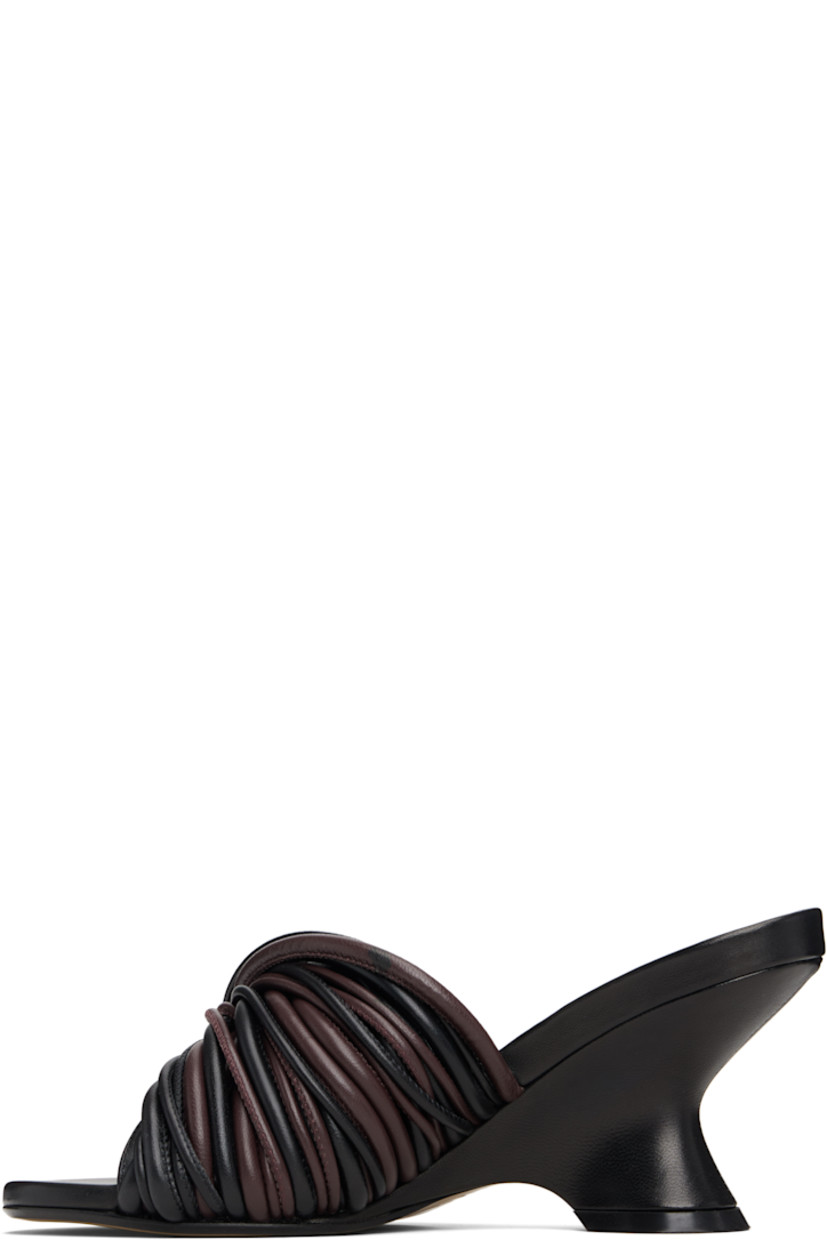 Buffed leather slip-on heeled sandals.

· Open toe
· Twisted straps at vamp
· Logo stamp at padded footbed
· Covered wedge heel with rubber injection
· Leather sole
· Heel: H3"

Supplier color: Dark brown