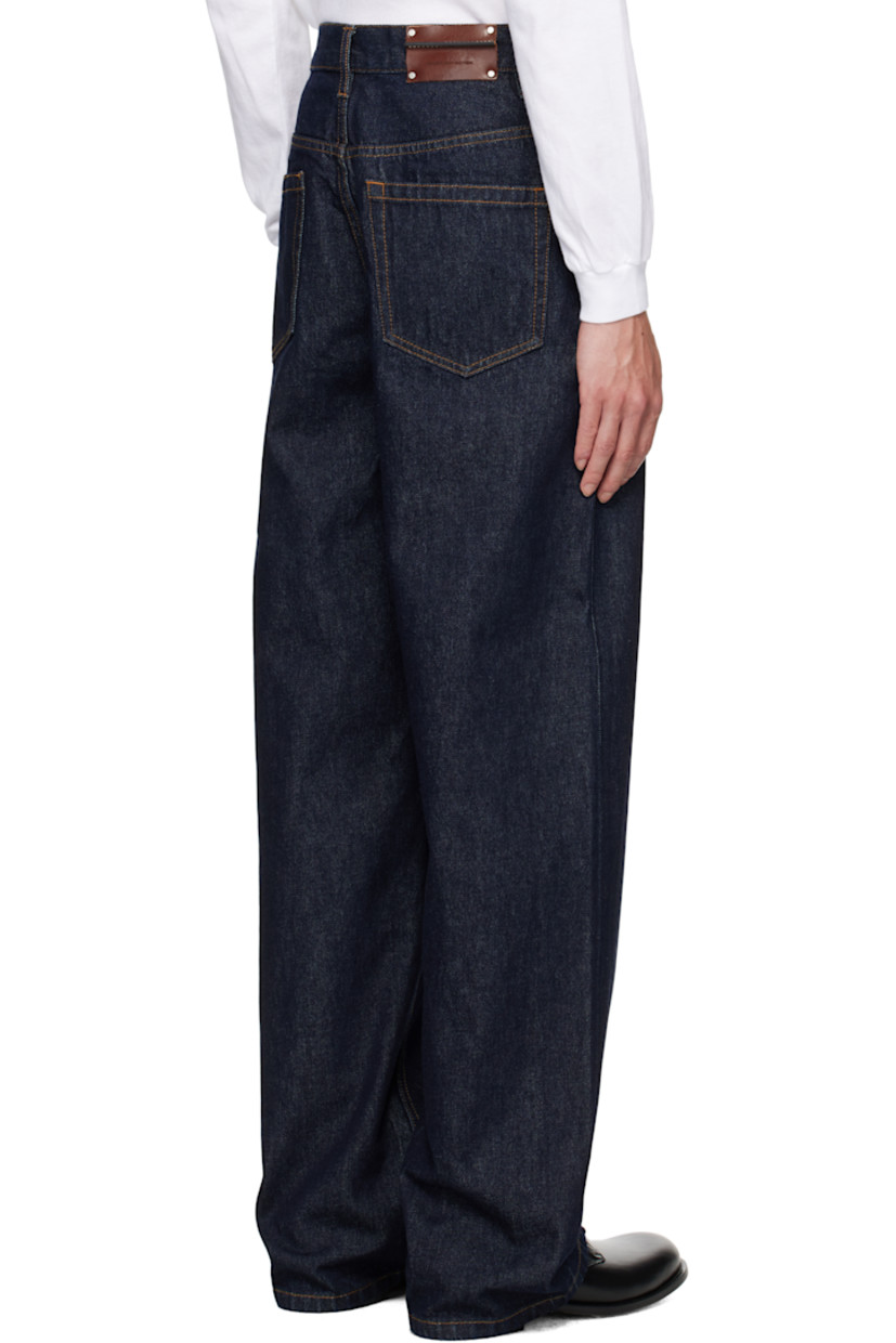 Non-stretch denim jeans.

· Loose-fit
· Belt loops
· Five-pocket styling
· Button fly
· Pinched leather logo patch at back waistband
· Logo-engraved silver-tone hardware
· Contrast stitching in tan

Supplier color: Indigo