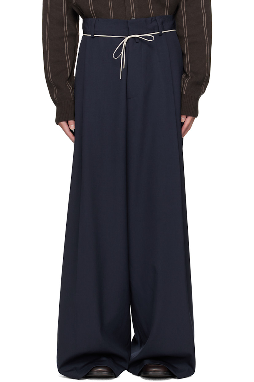 Wool canvas trousers.

· Belt loops
· Self-tie drawstring at waistband
· Four-pocket styling
· Zip fly
· Loop at front waistband
· Pleats at waist
· Creased legs

Supplier color: Navy
