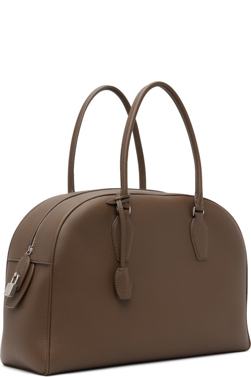 Grained calfskin top handle bag.

· Rolled carry handles
· Detachable sheathed key at handle
· Logo-engraved padlock at side
· Zip closure
· Zip and patch pocket at interior
· Buffed leather lining
· H10" x W15.5" x D5"

Supplier color: Dark olive