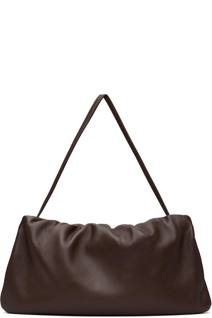 Buffed lambskin shoulder bag.

· Adjustable shoulder strap
· Logo embossed at face
· Gathering at zip closure
· Zip pocket at interior
· Buffed leather lining
· H7" x W12.5" x D1.5"

Supplier color: Brown melange