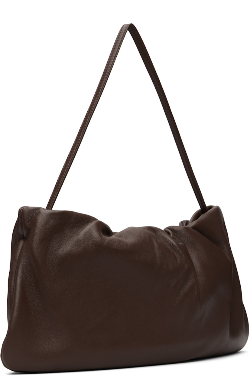 Buffed lambskin shoulder bag.

· Adjustable shoulder strap
· Logo embossed at face
· Gathering at zip closure
· Zip pocket at interior
· Buffed leather lining
· H7" x W12.5" x D1.5"

Supplier color: Brown melange