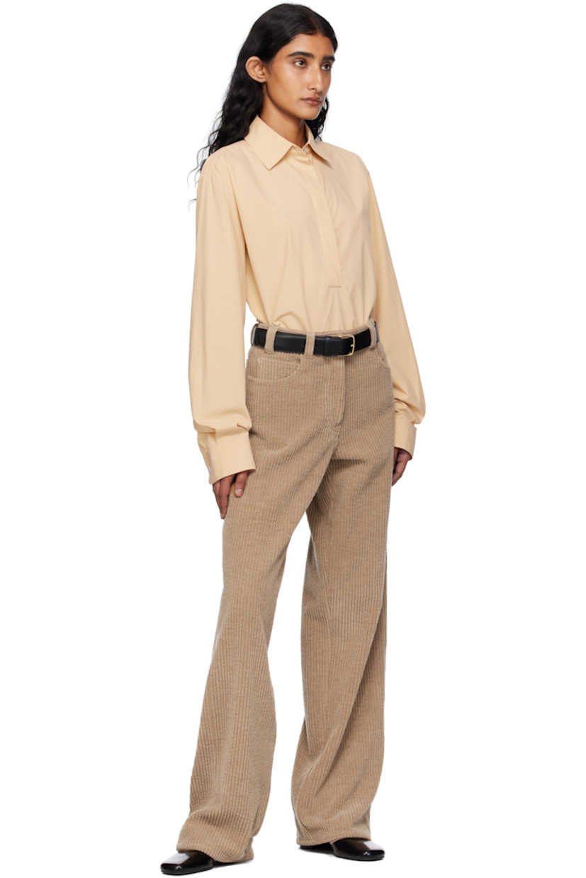 Lightweight sanded cotton poplin shirt. 

· Spread collar
· Concealed five-button placket 
· Shirttail hem 
· Buttoned barrel cuffs
· Mother-of-pearl hardware 

Supplier color: Sand