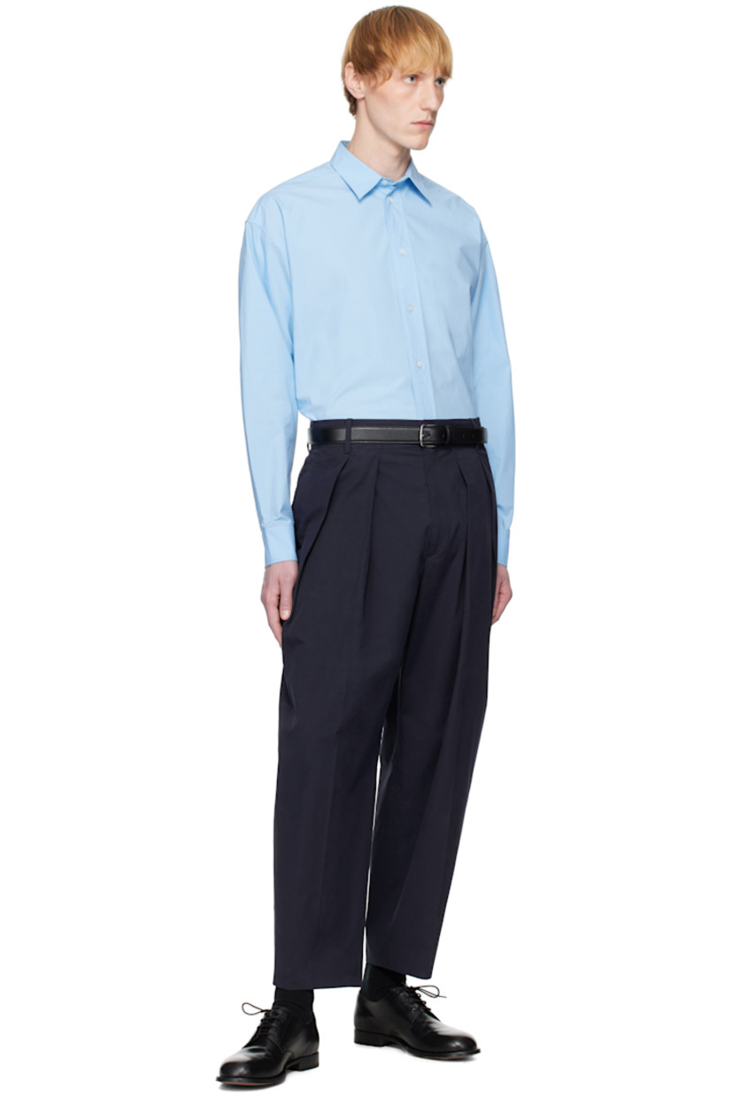 Cotton poplin shirt. 

· Spread collar
· Button closure 
· Shirttail hem
· Dropped shoulders
· Pleats at buttoned barrel cuffs
· Twin pleats at back yoke 

Supplier color: Powder blue