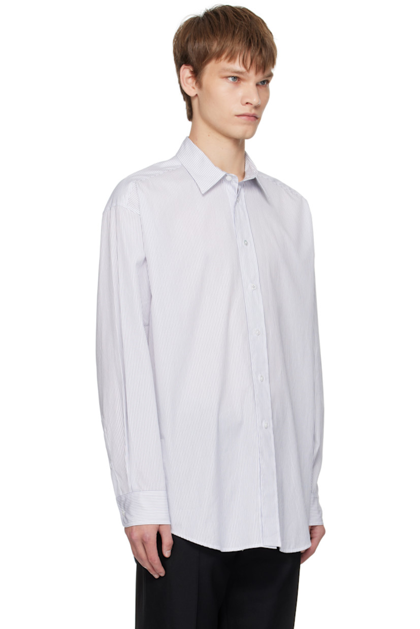 Cotton poplin shirt. 

· Spread collar
· Button closure
· Shirttail hem
· Pleats at buttoned barrel cuffs
· Twin pleats at back yoke 

Supplier color: White