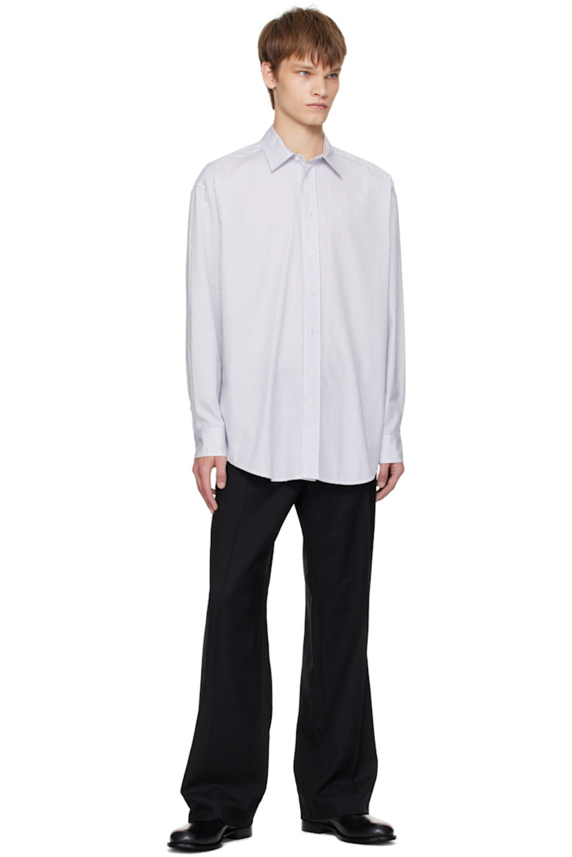 Cotton poplin shirt. 

· Spread collar
· Button closure
· Shirttail hem
· Pleats at buttoned barrel cuffs
· Twin pleats at back yoke 

Supplier color: White