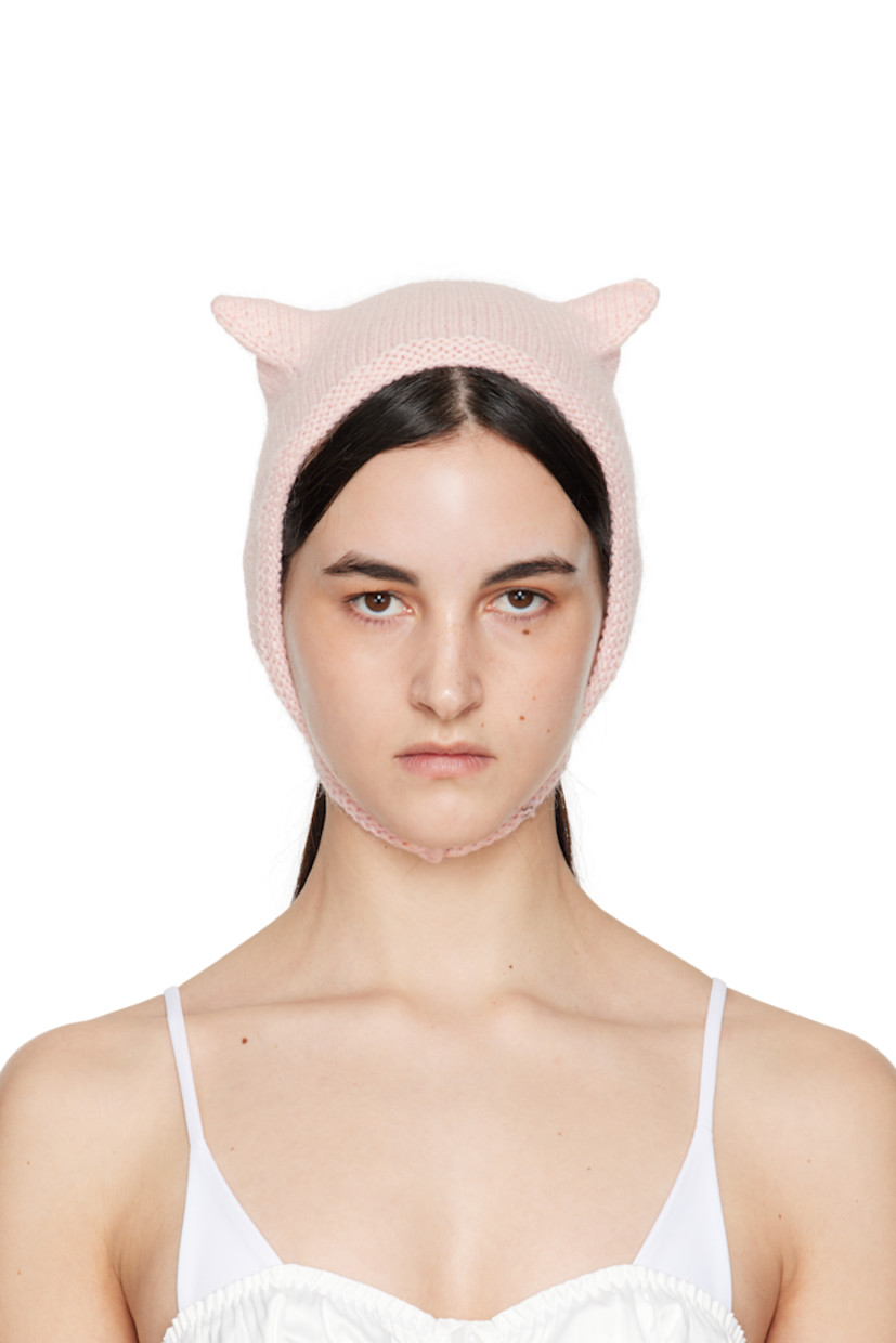 Brushed knit mink wool beanie in pink.

· Ear appliqués at crown
· Hook-eye chin strap

Supplier color: Baby pink

100% mink wool.