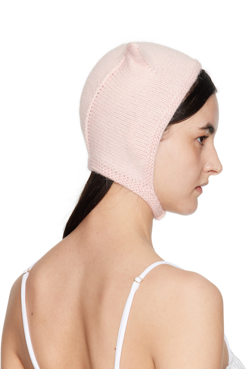 Brushed knit mink wool beanie in pink.

· Ear appliqués at crown
· Hook-eye chin strap

Supplier color: Baby pink

100% mink wool.