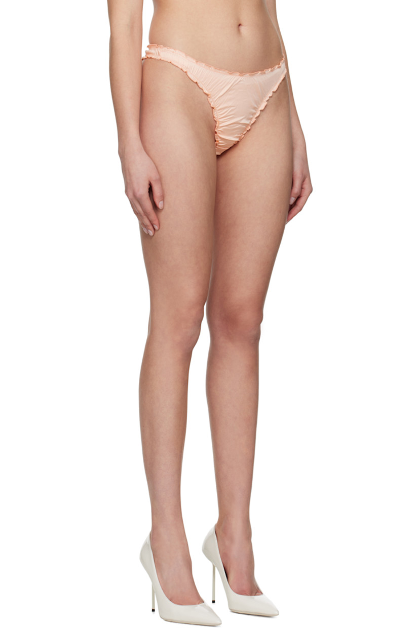 Stretch nylon satin thong. Ruffled edges and ruching throughout.

· Elasticized waistband
· Partial jersey lining

Supplier color: Coral