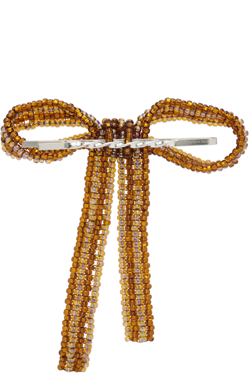 Handcrafted hair pin in steel. 

· Beaded glass bow accent at face 
· H3" x W2.5"

Supplier color: Brown