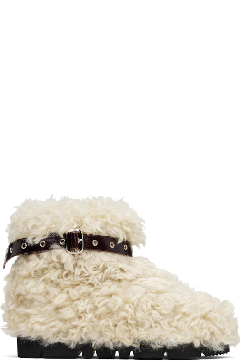 Ankle-high faux-fur boots.

· Patent faux-leather pin-buckle strap at collar 
· Padded footbed
· Treaded rubber sole 

Supplier color: Beige sheep