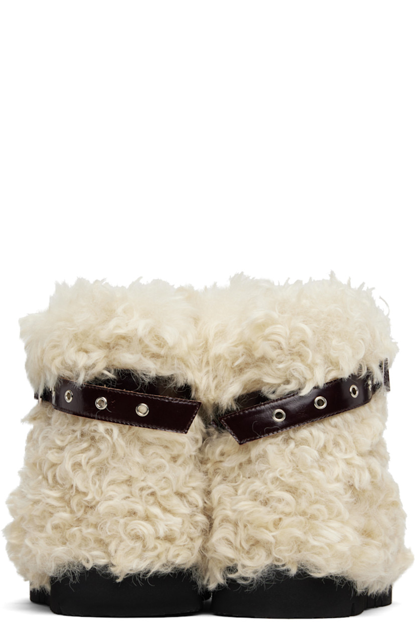 Ankle-high faux-fur boots.

· Patent faux-leather pin-buckle strap at collar 
· Padded footbed
· Treaded rubber sole 

Supplier color: Beige sheep
