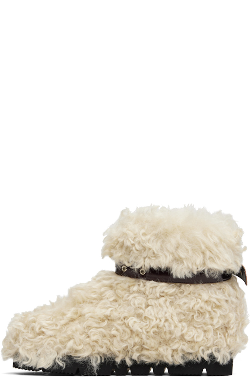 Ankle-high faux-fur boots.

· Patent faux-leather pin-buckle strap at collar 
· Padded footbed
· Treaded rubber sole 

Supplier color: Beige sheep