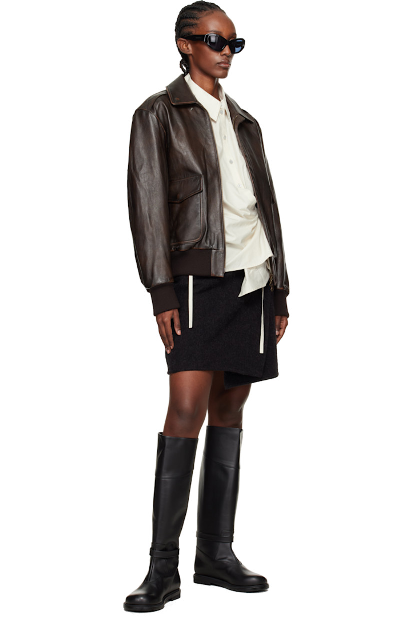 Knee-high buffed leather boots. 

· Post-stud strap at vamp
· Pigskin lining
· Stacked rubber midsole 
· Treaded rubber sole 

Supplier color: Black