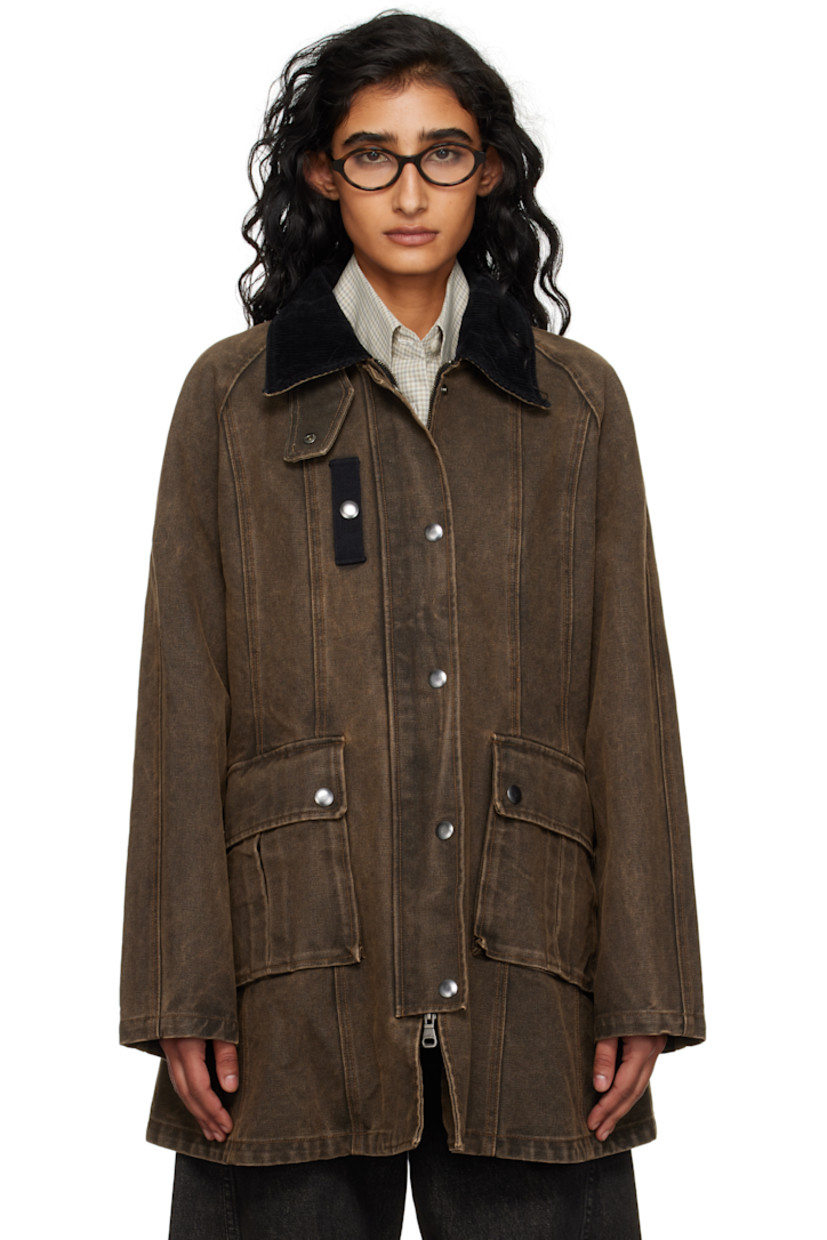 Cotton canvas jacket. 

· Fading throughout 
· Press-stud tab at corduroy spread collar 
· Concealed two-way zip closure
· Press-stud placket
· Webbing strap with rivets at chest and back collar 
· Flap pockets at front 
· Raglan sleeves
· Storm flap at back yoke 
· Contrast stitching in tan 

Supplier color: Brown