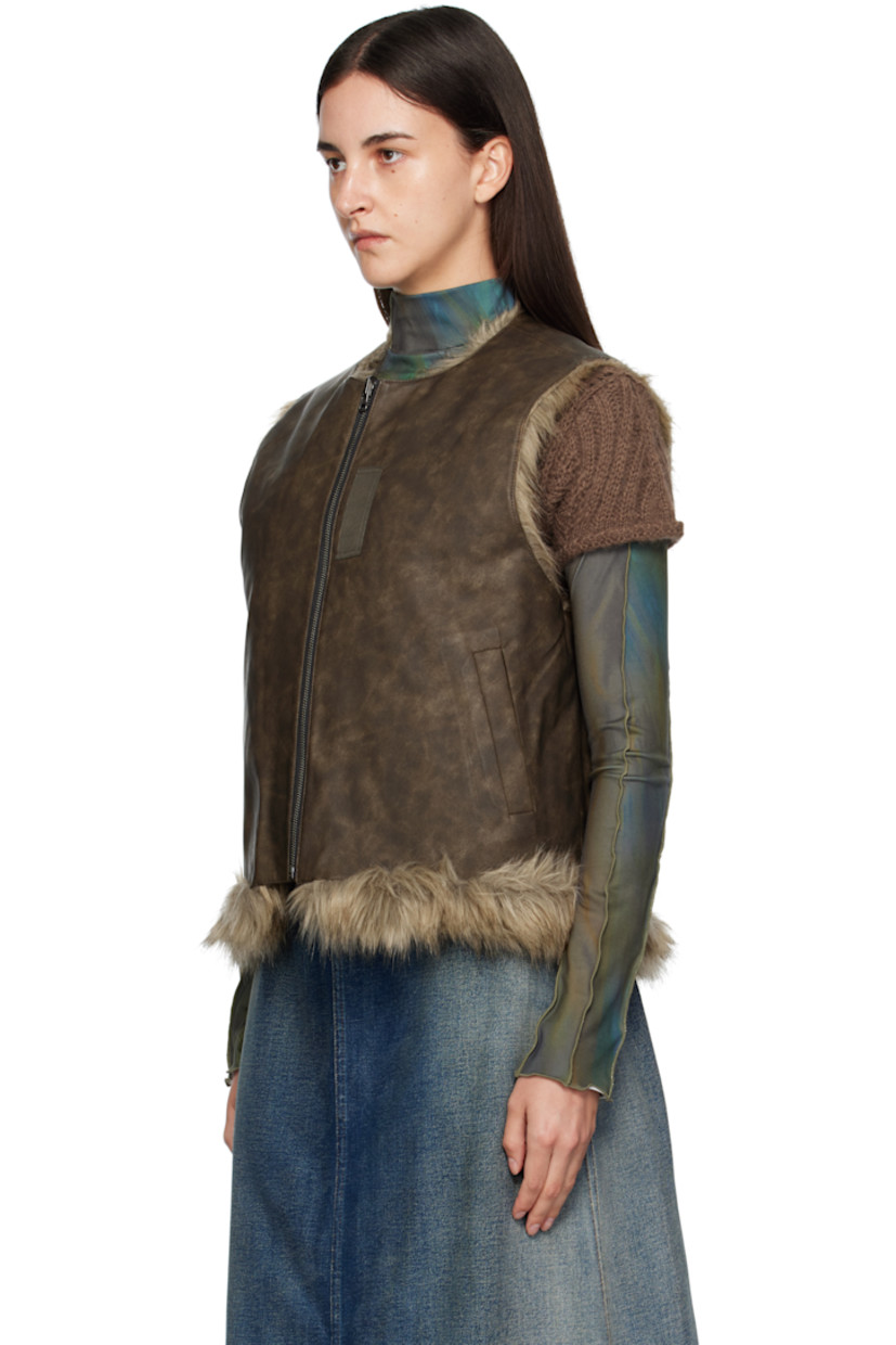 Reversible padded faux-fur vest.

Reverse in brown grained faux-leather.

· Round neck
· Zip closure
· Offset quilted button placket
· Welt pockets at waist and interior

Supplier color: Brown