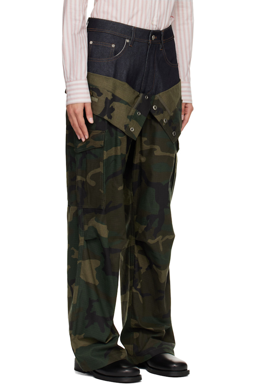 Cotton-blend ripstop and non-stretch denim cargo pants.

· Camouflage pattern printed throughout
· Layered foldover waistband
· Belt loops
· Five-pocket styling
· Zip fly
· Pleats at knees
· Loops and cargo pocket at outseams
· Contrast stitching in tan
· Logo patch at back

Supplier color: Navy/Green