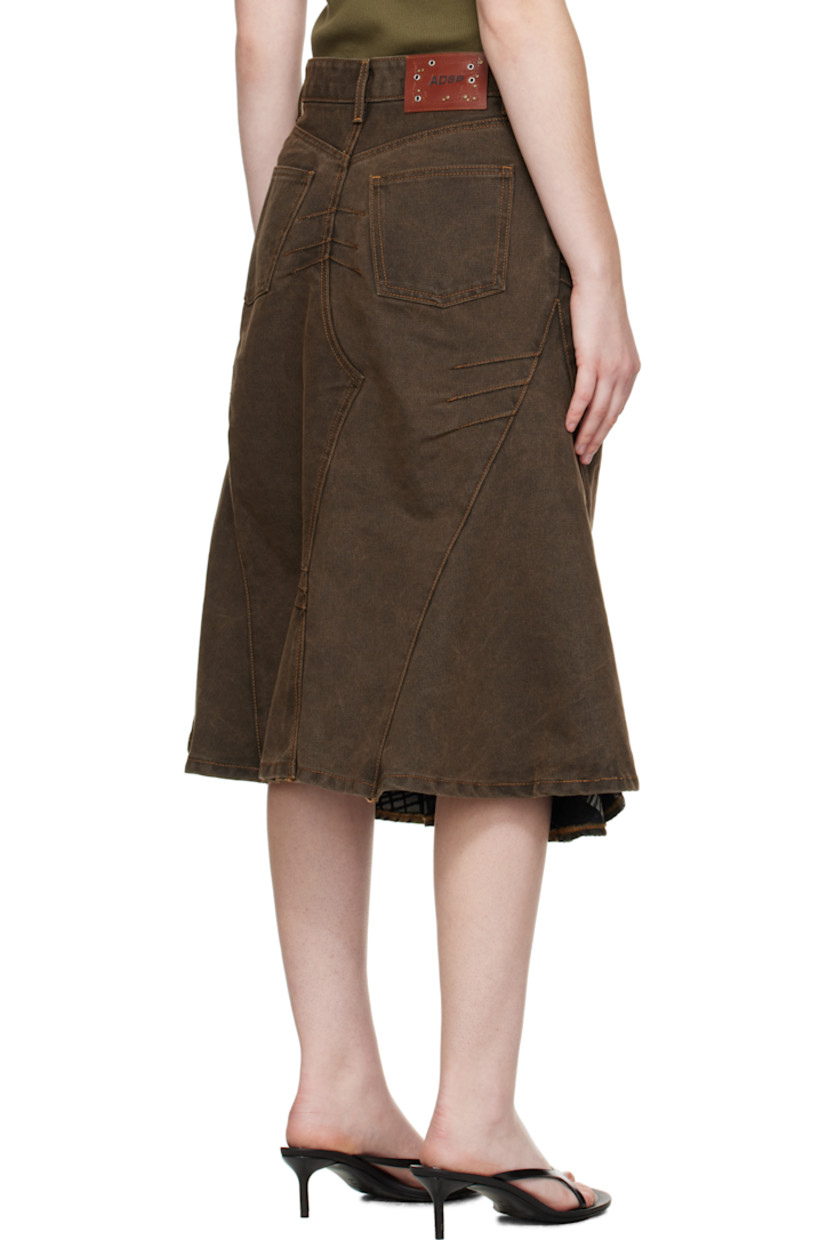 Non-stretch denim midi skirt.

· Fading throughout
· Paneled construction
· Darts throughout
· Belt loops at waist
· Five-pocket styling
· Zip fly
· Layered hem
· Leather logo patch at back waist

Supplier color: Sunset Brown