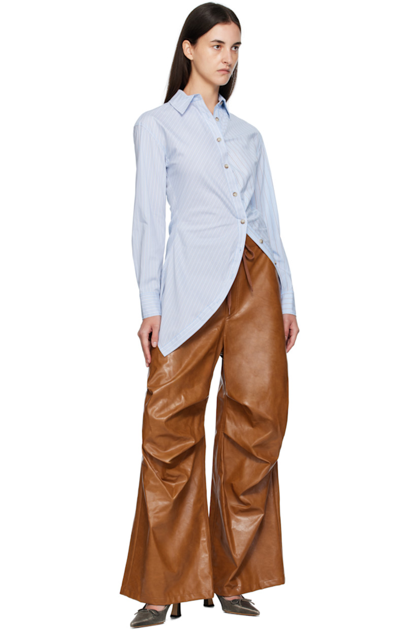 Stretch cotton-blend poplin shirt.

· Stripes throughout
· Spread collar
· Offset button closure
· Asymmetrical hem

Supplier color: Blue