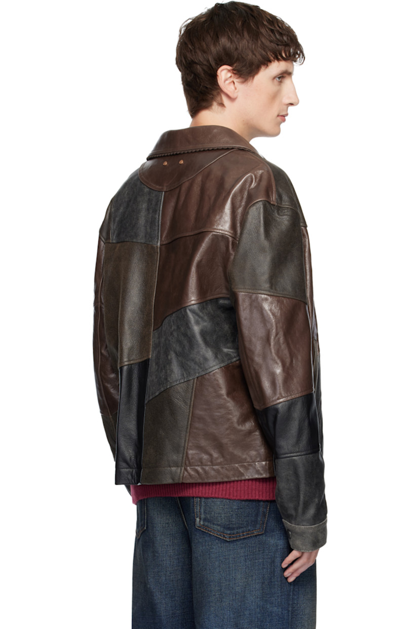 Grained leather jacket. 

· Patchwork construction 
· Smudging throughout 
· Spread collar 
· Press-stud closure
· Welt pockets at front 
· Pleats at buttoned barrel cuffs
· Logo discs at back collar 
· Welt and patch pocket at interior 
· Full satin twill lining 

Supplier color:  Mud black/Brown