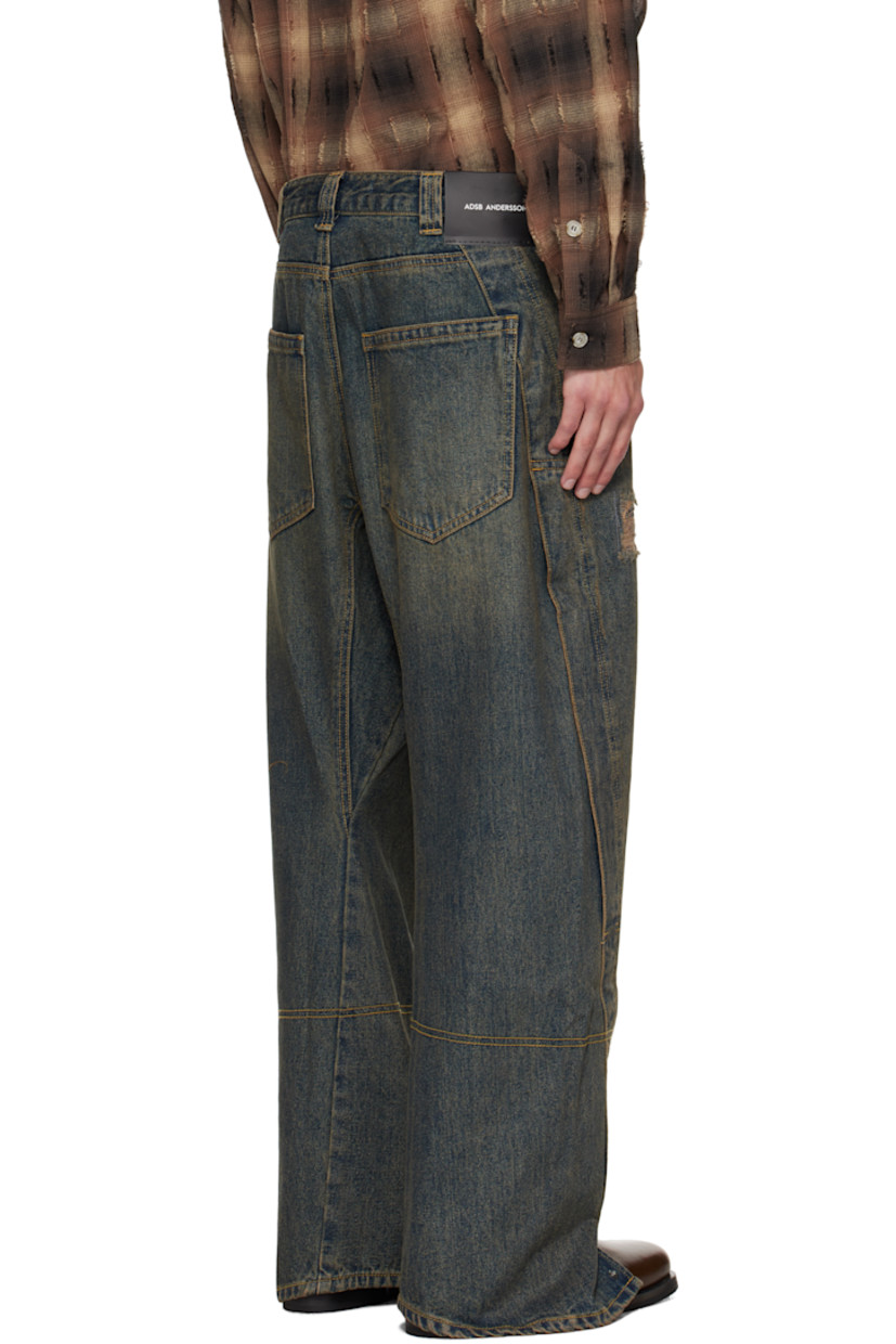 Non-stretch denim jeans.

· Fading, whiskering, and distressing throughout
· Belt loops
· Four-pocket styling
· Zip fly
· Press-stud vent at cuffs
· Twisted outseams
· Logo patch at back waistband
· Contrast stitching in tan

Supplier color: Dusty blue