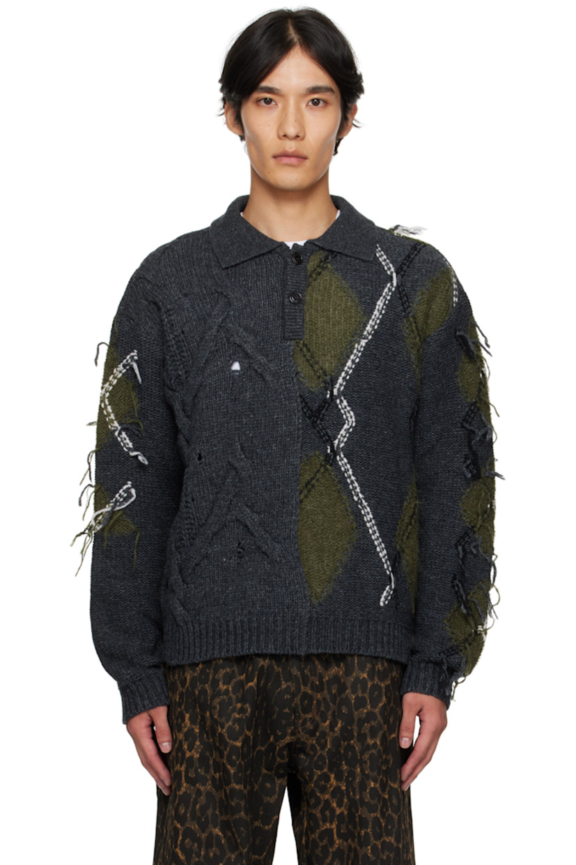 Knit and reverse-knit wool-blend sweater.

· Cable-knit and intarsia argyle patterns throughout
· Loose threads and open-knit detailing
· Rib-knit spread collar, hem, and cuffs
· Two-button placket

Supplier color: Grey charcoal