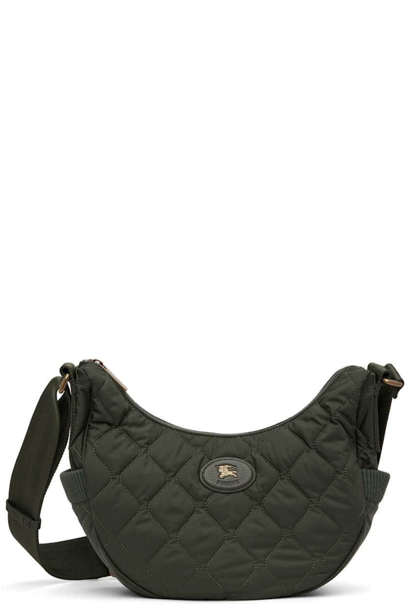 Quilted technical nylon satin messenger bag.

· Adjustable crossbody strap
· Leather logo patch at face
· Rib-knit patch pocket at sides
· Magnetic compartment at back face
· Zip closure
· Check-patterned lining
· H8" x W13" x D4"

Supplier color: Shale