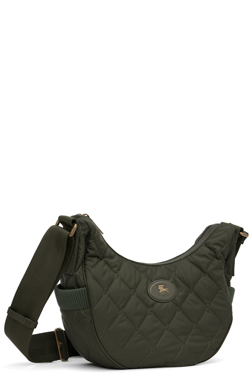 Quilted technical nylon satin messenger bag.

· Adjustable crossbody strap
· Leather logo patch at face
· Rib-knit patch pocket at sides
· Magnetic compartment at back face
· Zip closure
· Check-patterned lining
· H8" x W13" x D4"

Supplier color: Shale