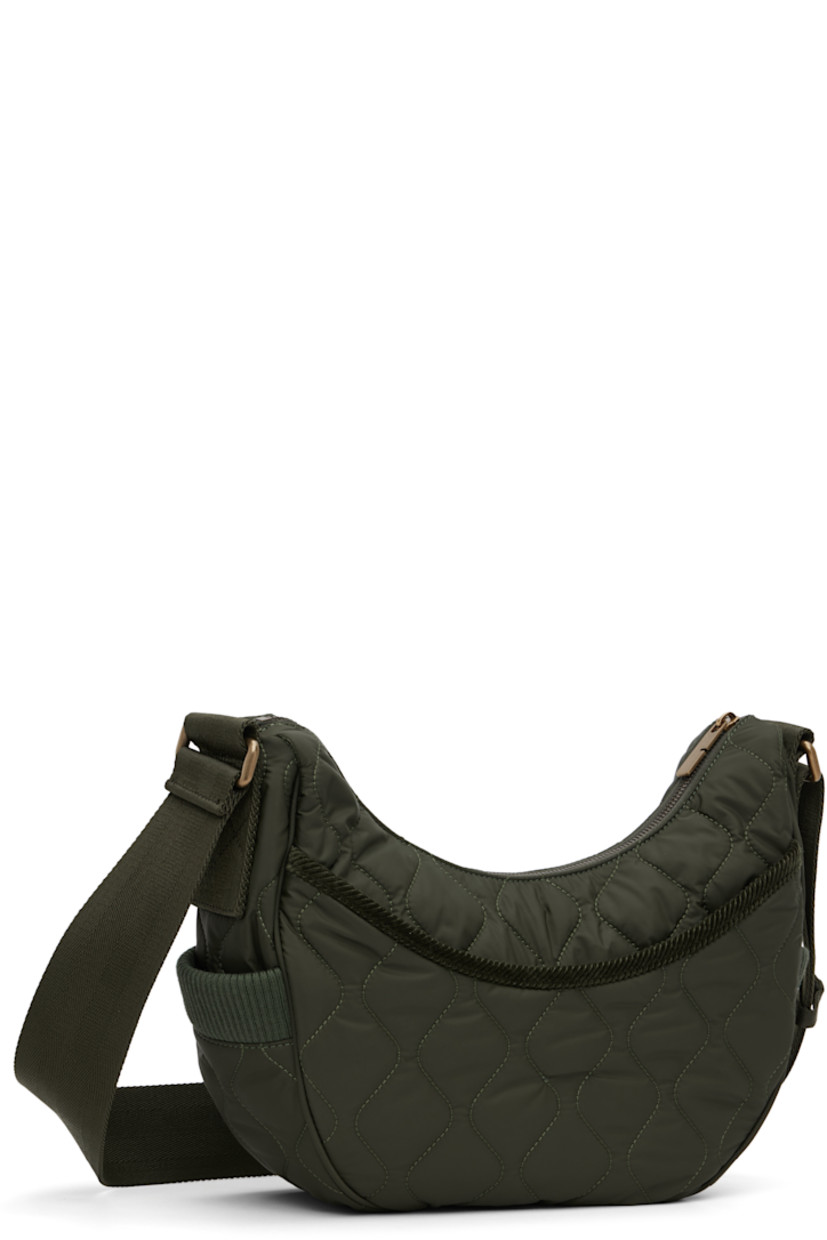 Quilted technical nylon satin messenger bag.

· Adjustable crossbody strap
· Leather logo patch at face
· Rib-knit patch pocket at sides
· Magnetic compartment at back face
· Zip closure
· Check-patterned lining
· H8" x W13" x D4"

Supplier color: Shale