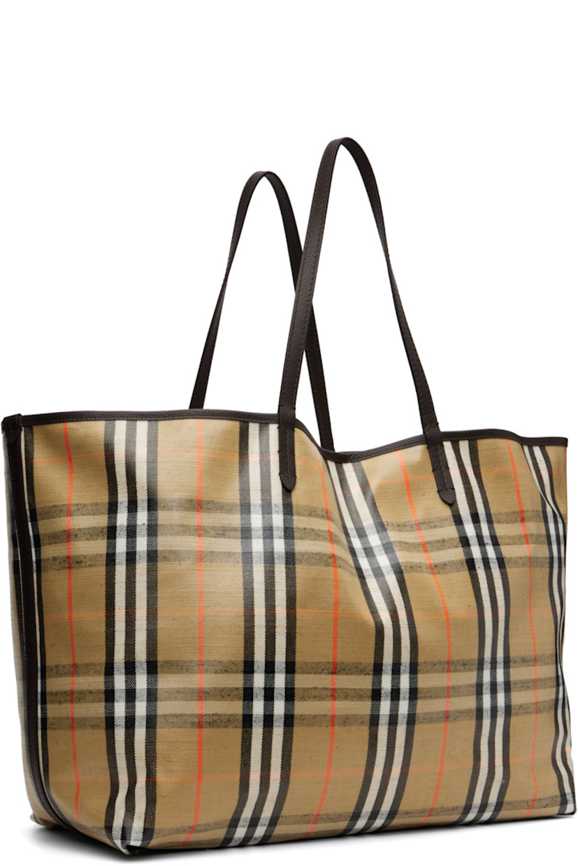 Coated canvas and pebble-grained calfskin tote. 

· Hand-painted edges
· Jacquard signature check pattern throughout 
· Fixed shoulder straps 
· Logo hardware at face
· Press-stud tab closure
· Detachable zip pouch at interior 
· Unlined
· H14" x W18" x D8.5"

Supplier color: Sand