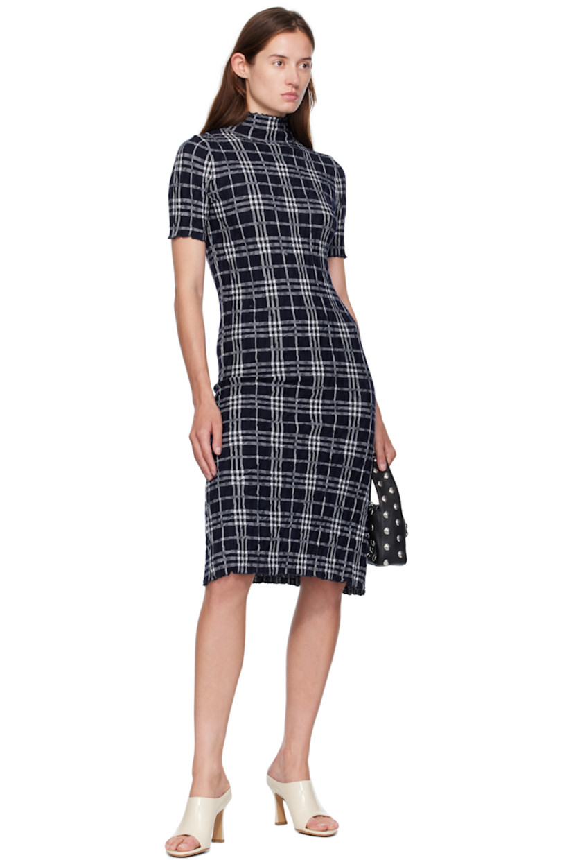 Knit wool midi dress. 

· Reverse knit pattern and jacquard check pattern
· Ruffled edge at mock neck, hem, and cuffs

Supplier color: Ink/Chalk