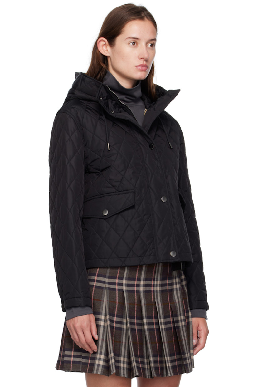 Insulated and quilted reused nylon satin jacket. 

· Cord-lock drawstring at hood
· Two-way zip closure and press-stud placket
· Flap pockets at waist
· Press-stud fastening at cuffs
· Patch pocket at interior 
· Check-patterned cotton twill lining 

Supplier color: Black