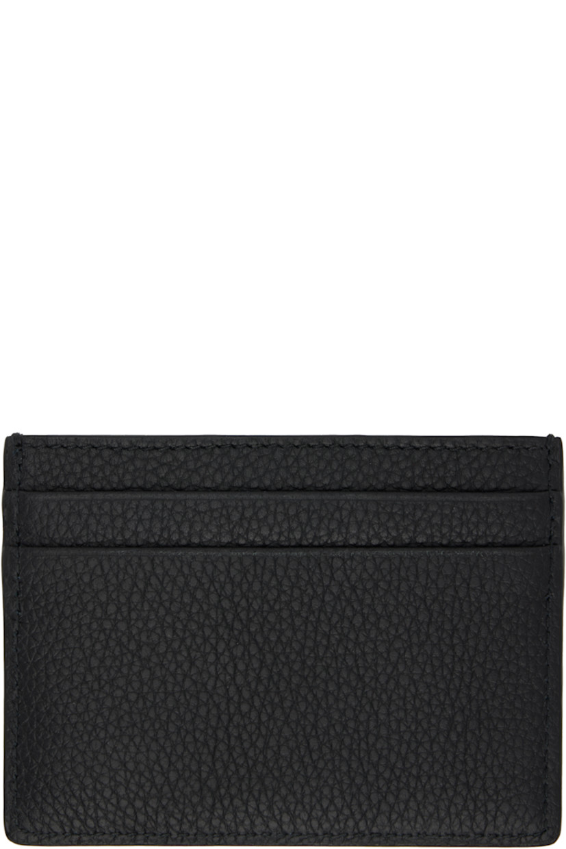 Pebble-grained calfskin card holder. 

· Logo hardware at face
· Four card slots and central note slot 
· Lambskin interior 
· Signature check pattern at twill lining 
· H3" x W4"

Supplier color: Black