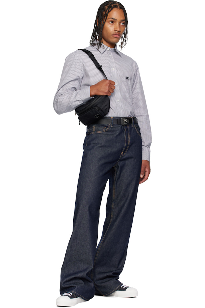 Nylon canvas belt bag. 

· Woven check pattern throughout 
· Adjustable crossbody strap
· Zip pocket with logo plaque at face
· Zip closure
· Poplin lining
· H6" x W10" x D4.5"

Supplier color: Black