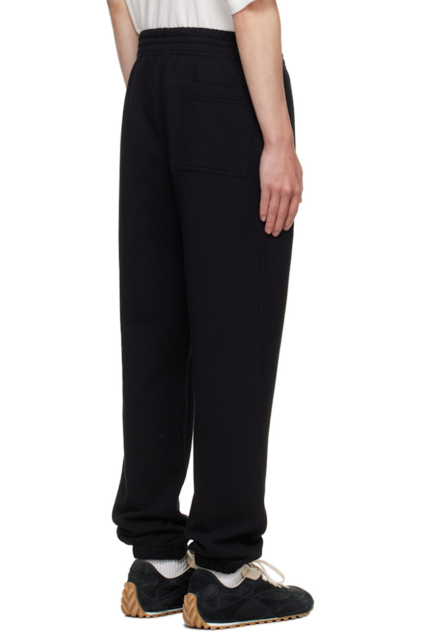 French terry sweatpants.

· Slim-fit
· Concealed drawstring at elasticized waistband
· Three-pocket styling
· Graphic patch and embroidered logo at front leg
· Elasticized cuffs

Supplier color: Black