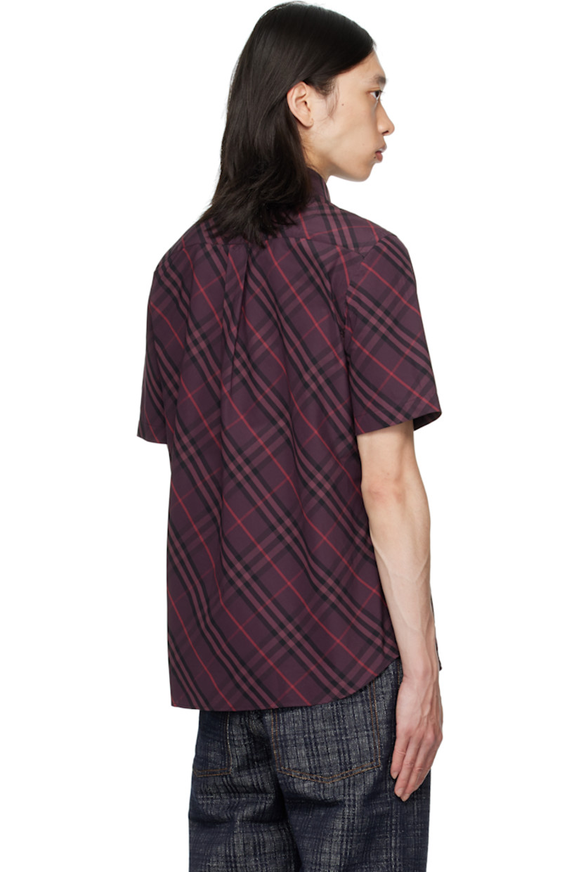 Cotton poplin shirt.

· Check pattern throughout
· Spread collar
· Button closure
· Shirttail hem
· Box pleat at back yoke

Supplier color: Rubus ip check